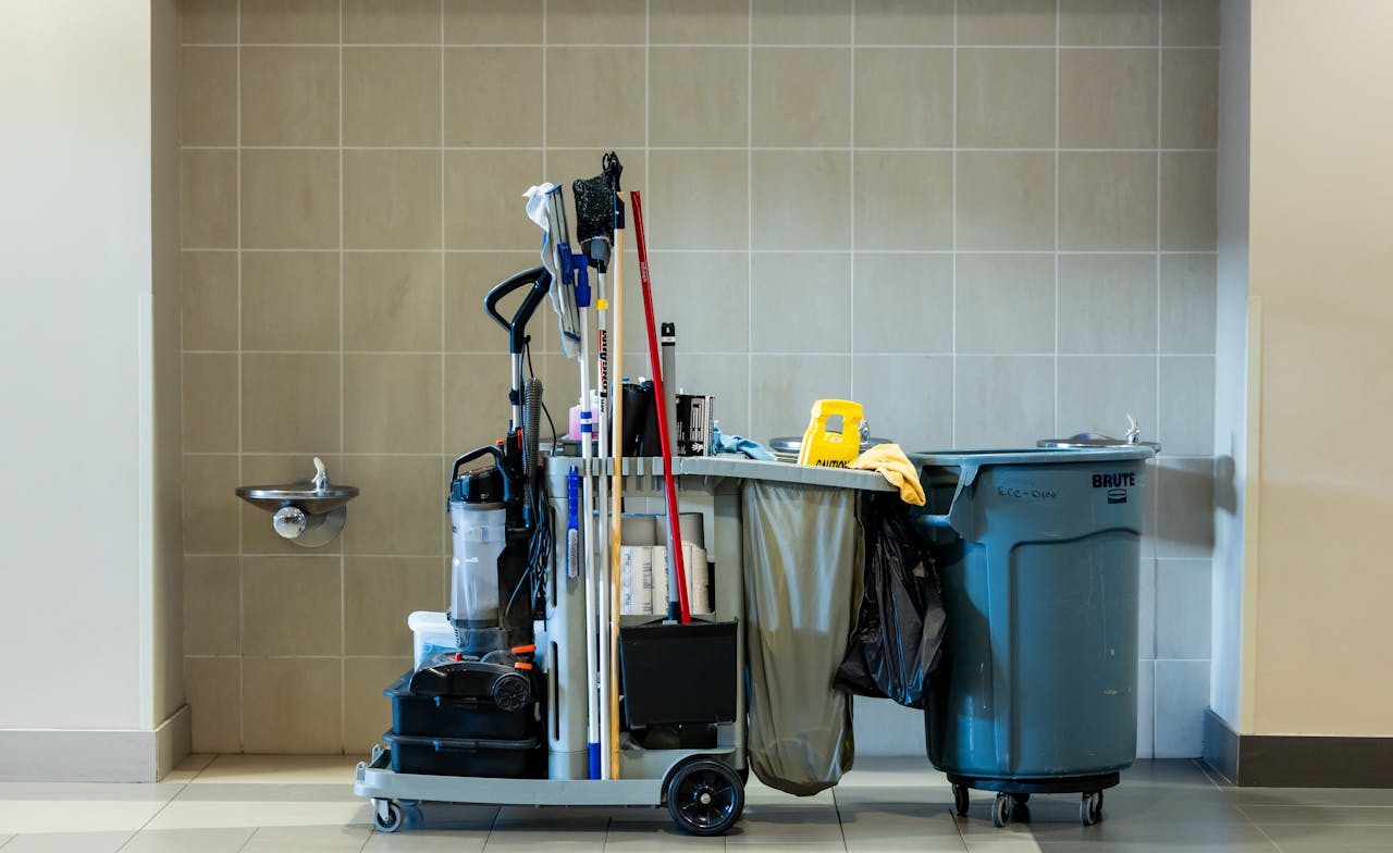 gallery-6 A comprehensive collection of professional cleaning tools on a cart in an indoor environment.